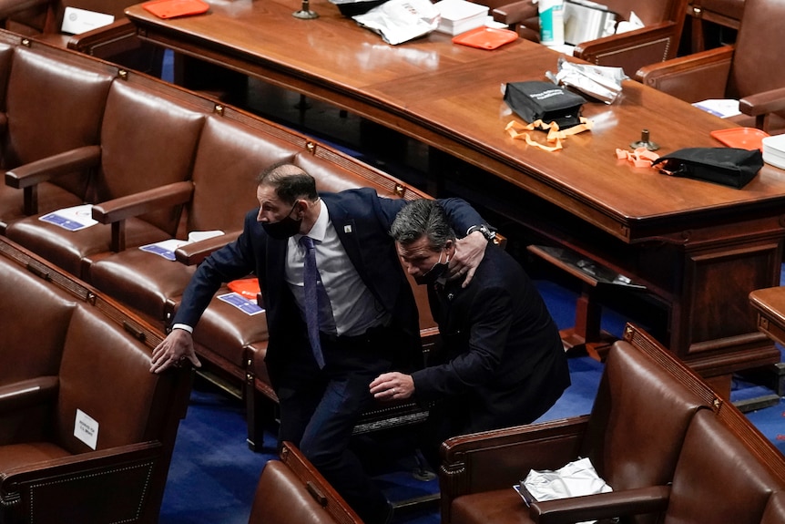 Politicians evacuate the House Chamber on January 6, 2021