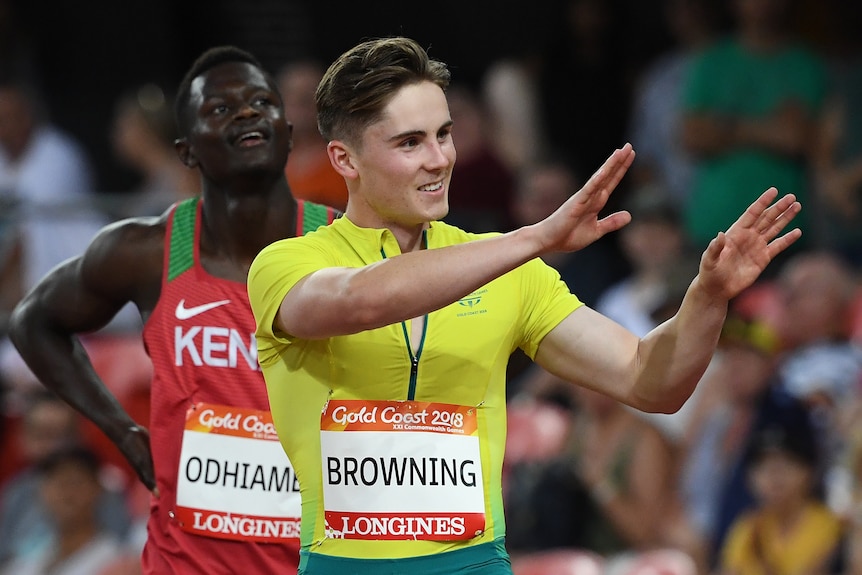 Rohan Browning waves to the crowd from the running track.