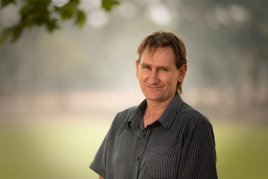 A man in a black-and-white collared shirt