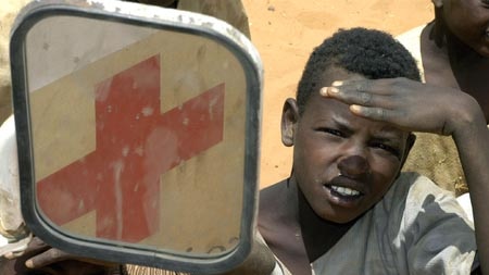 Sudanese boys welcome a Red Cross aid convoy.