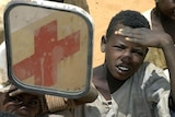 Sudanese boys welcome a Red Cross aid convoy.