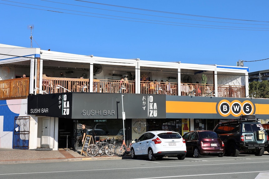 A street with a bar and bottle shop