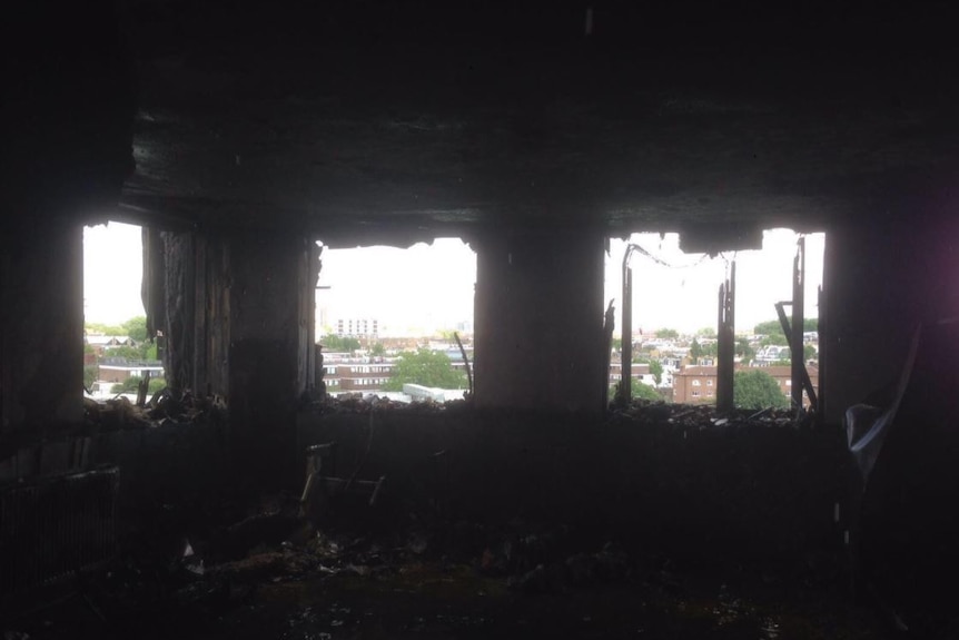 A high contrast image shows the bright skyline of Notting Hill outside a blackened room of Grenfell tower