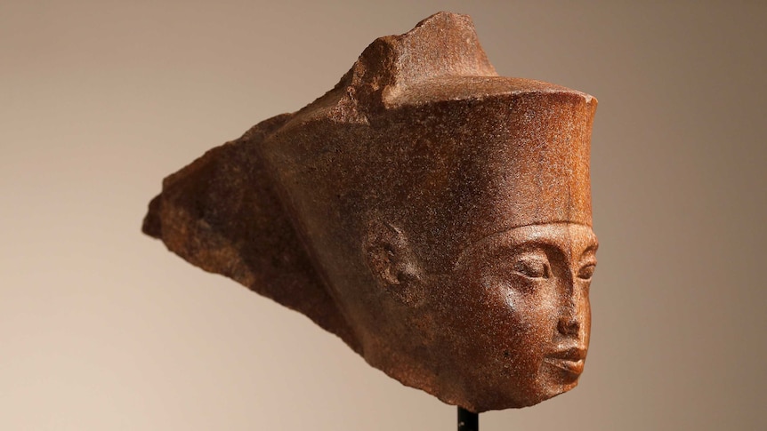 An Egyptian brown quartzite head of the God Amen