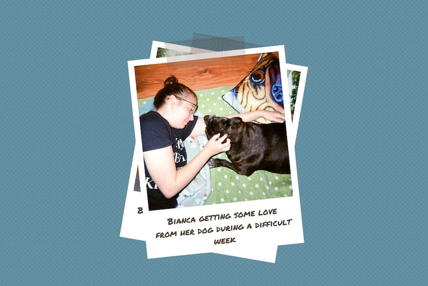 A young woman lies on the floor with her dog