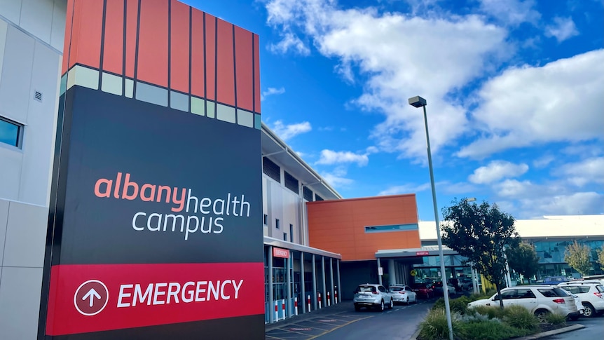 The red and navy Albany Health Campus sign at the entrance to the hospital