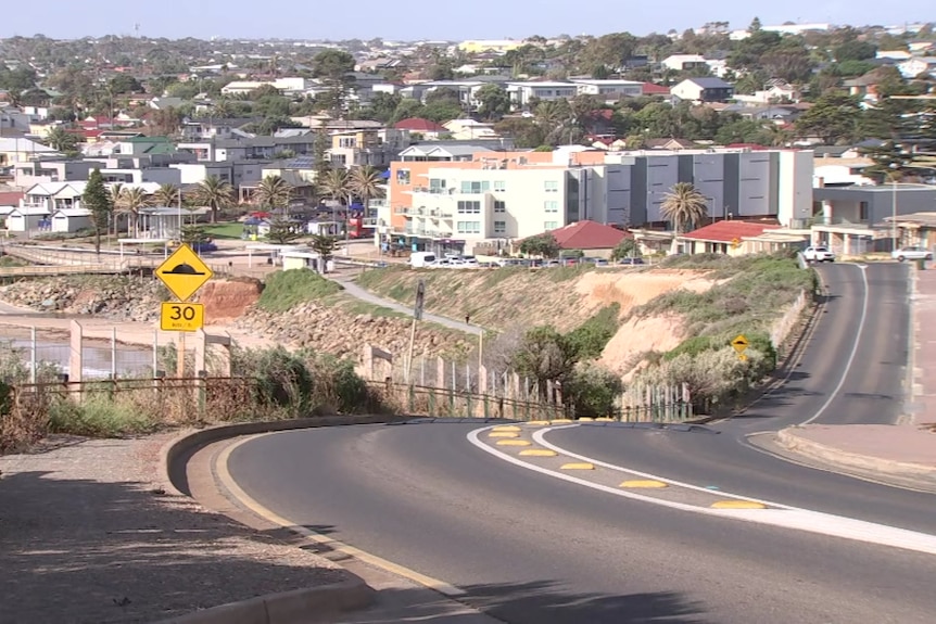 Houses and apartments on a windy road next to the beach