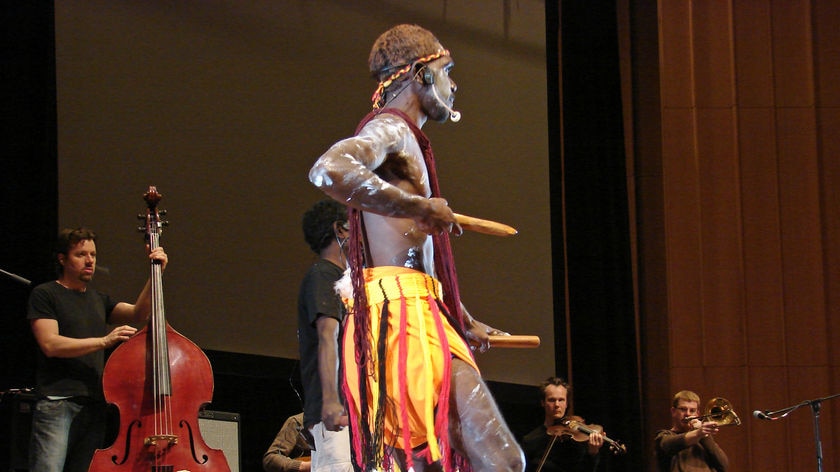 A dancer from the Young Wagilak Group performing 'Crossing Roper Bar' with the Australian Art Orchestra at the ANU's Llewellyn Hall.