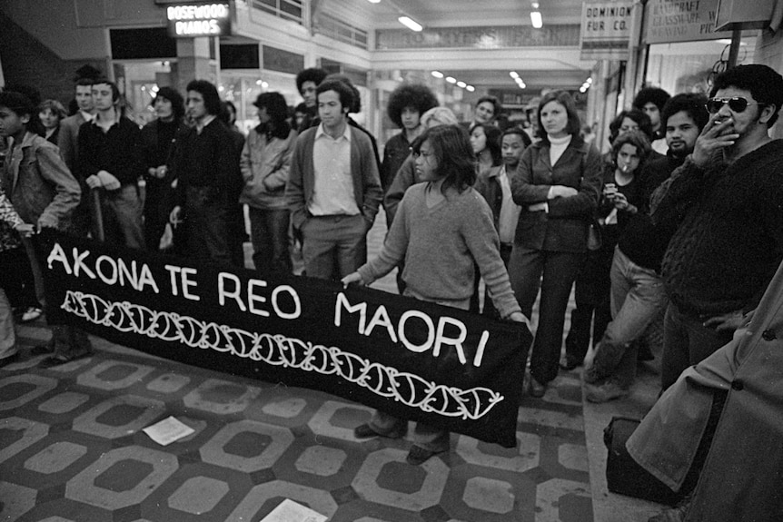A black and white image shows a banned that says 'akona te reo Maori'