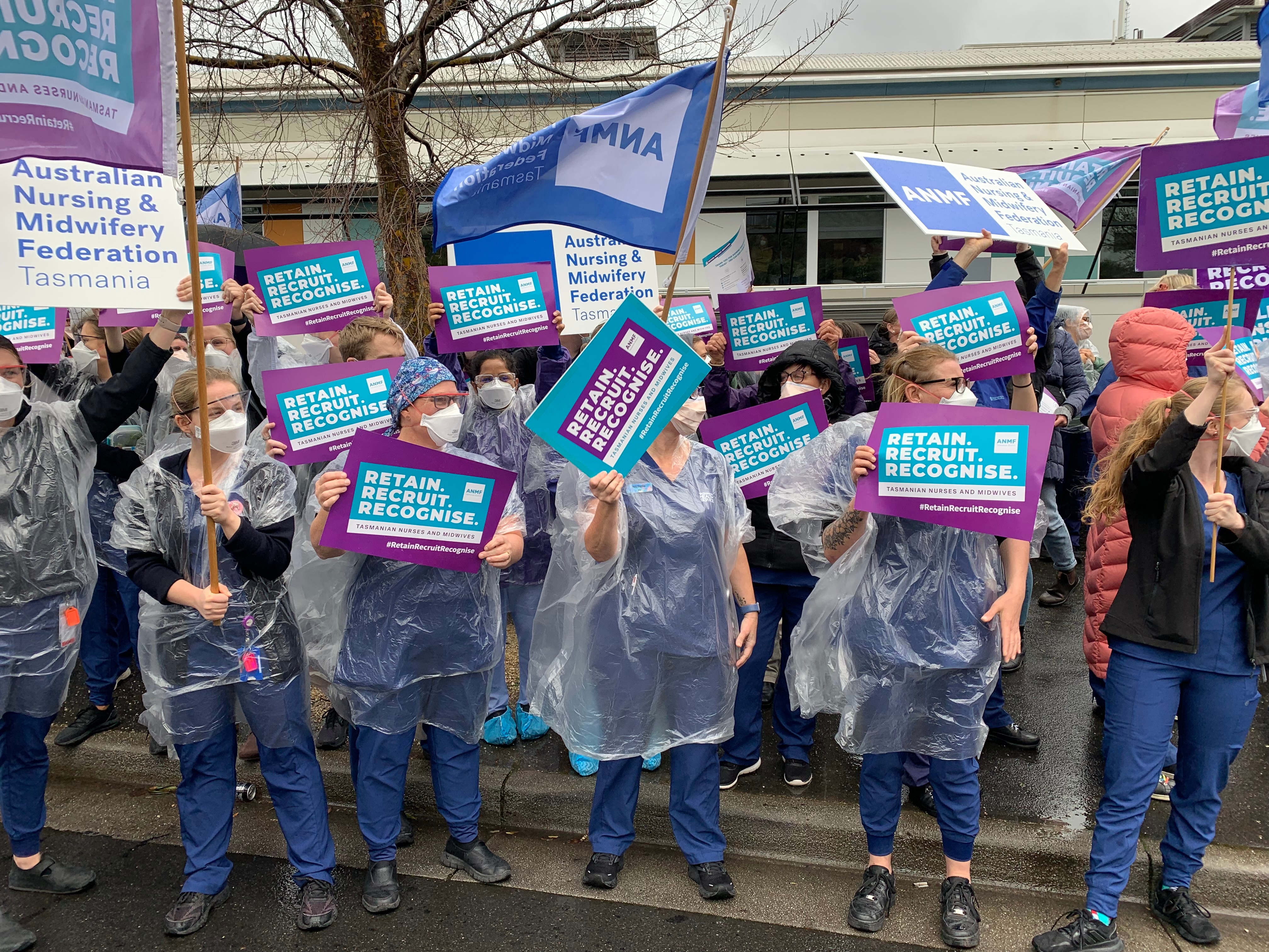 A group of nurses hold signs in protest in Launceston.