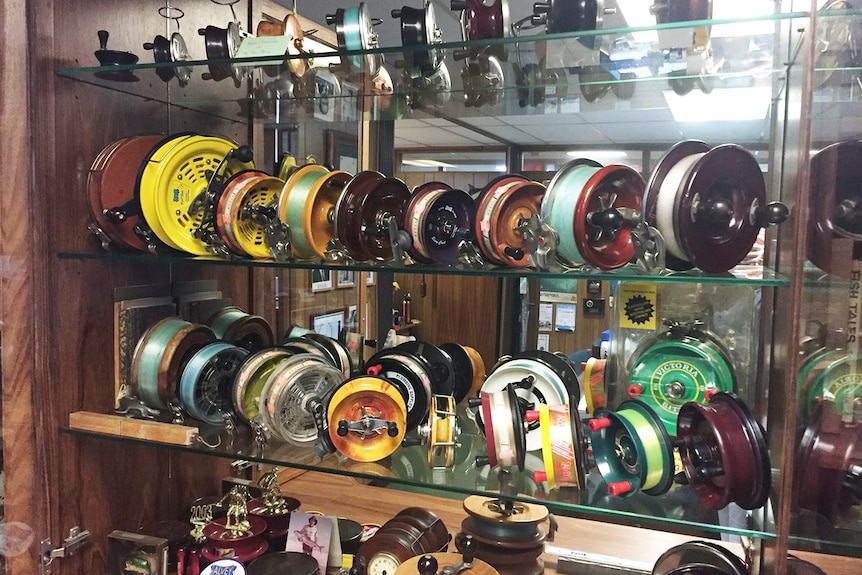 A range of historic Alvey reels displayed in a glass cabinet at the company's manufacturing facility at Carole Park at Ipswich.