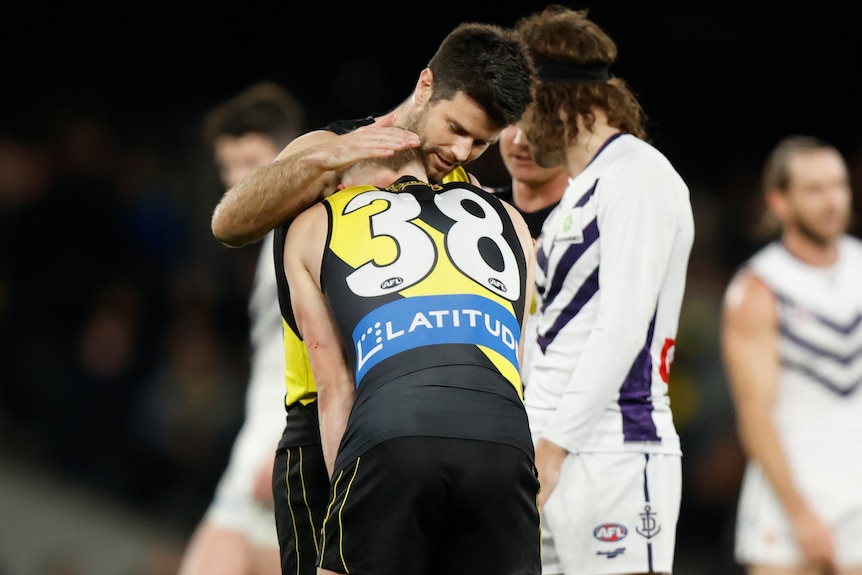 Noah Cumberland leans into Trent Cotchin's shoulder