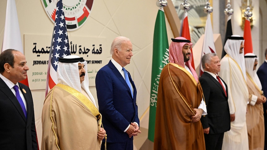 Leaders stand in a line for 'family' photo.