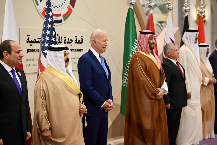 Leaders stand in a line for 'family' photo with Arab leaders