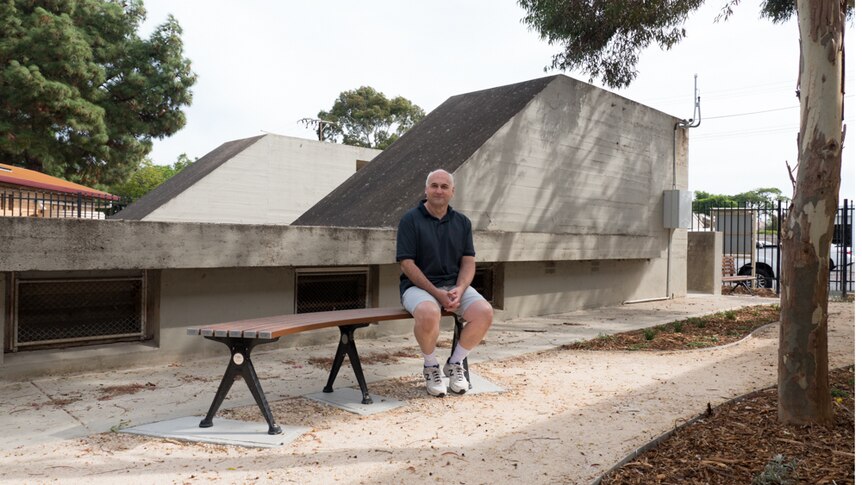 Neil Rossiter sits on a bench in the new air raid shelter garden.