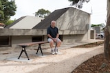Neil Rossiter sits on a bench in the new air raid shelter garden.