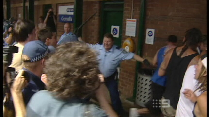 Screen grab of Craig Campbell beating back rioters at the Cronulla train station