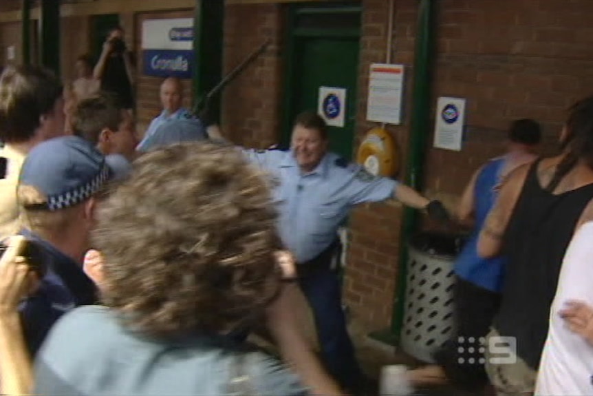 Screen grab of Craig Campbell beating back rioters at the Cronulla train station