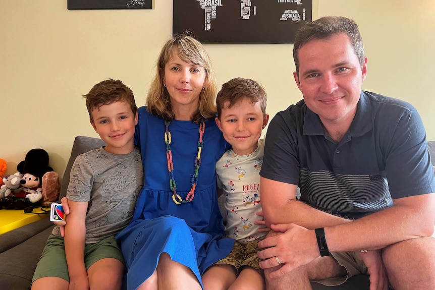  Dagmara Laukova and Jan Lauko with their children Julian and Vincent sitting on a couch. 