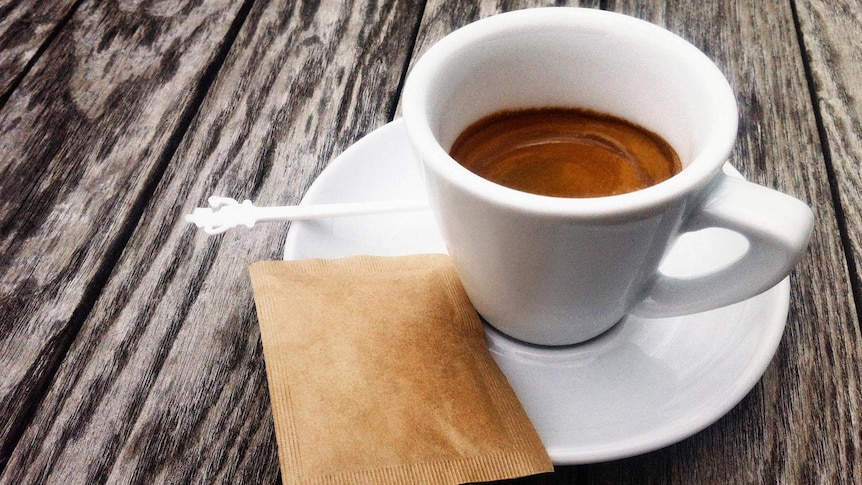 An espresso coffee sitting on a table.