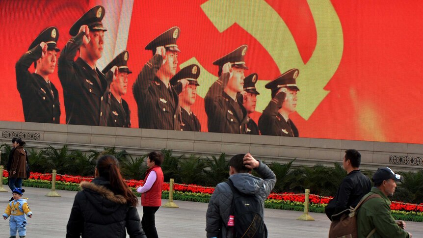 Tourists walk through Tiananmen Square on November 7, 2012.