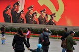 Tourists walk through Tiananmen Square on November 7, 2012.