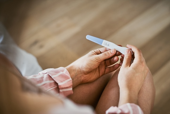 Woman holding pregnancy test