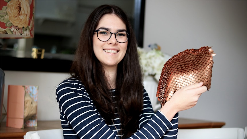 Macinley Butson holds her SMART Armour in her hands and smiles at the camera.