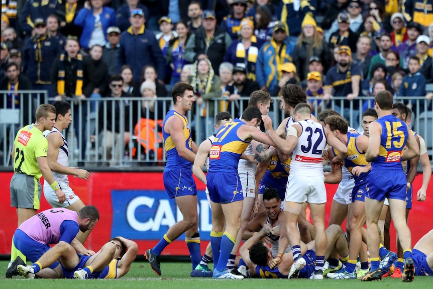 Scuffles break out after a tackle on Andrew Gaff (left)
