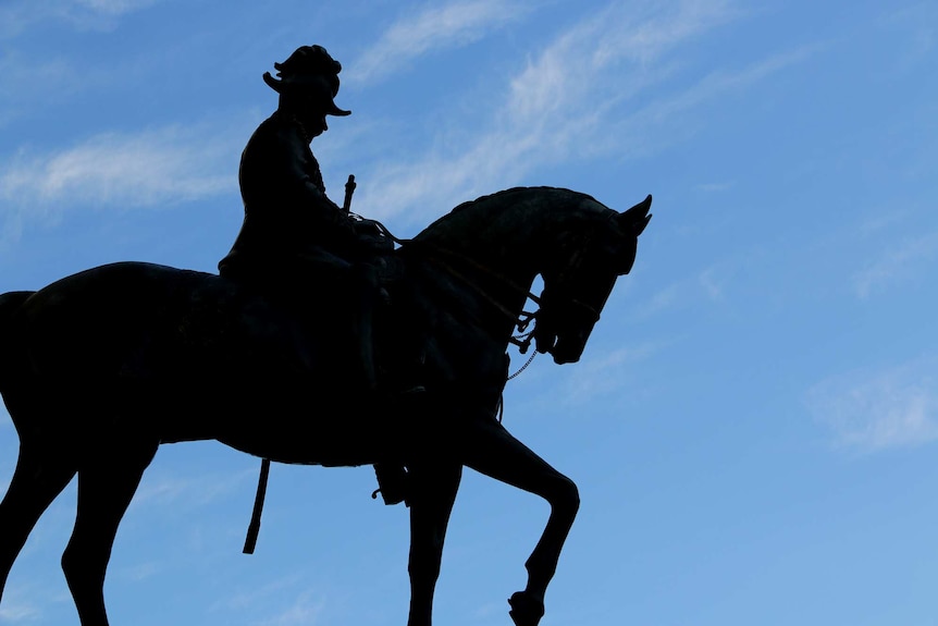 Silhouette of the Statue of King George V on a horse in King George Square.