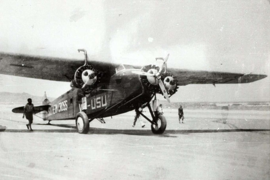 A light plane rests on Seven Mile Beach