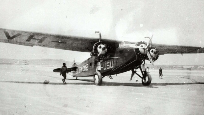 A plane rests on Seven Mile Beach