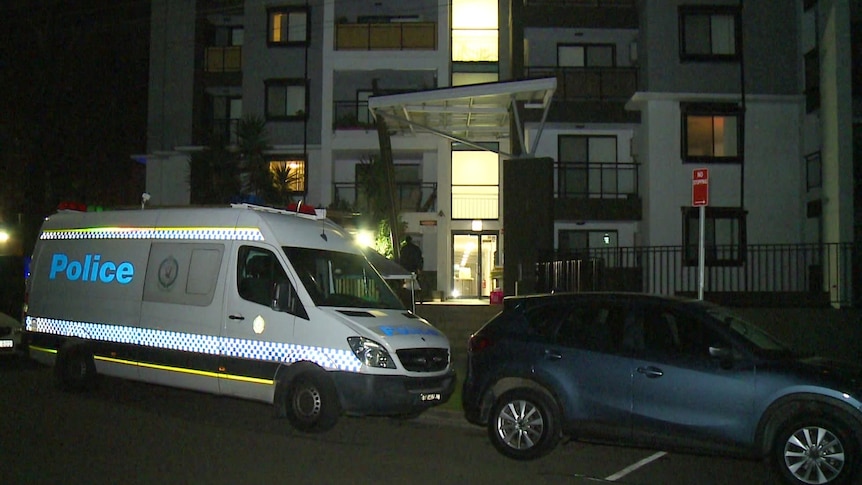 A unit block with a police car outside