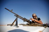 An anti-Gaddafi fighter mans a checkpoint, 1km north of the Libyan city of Bani Walid on September 15, 2011.