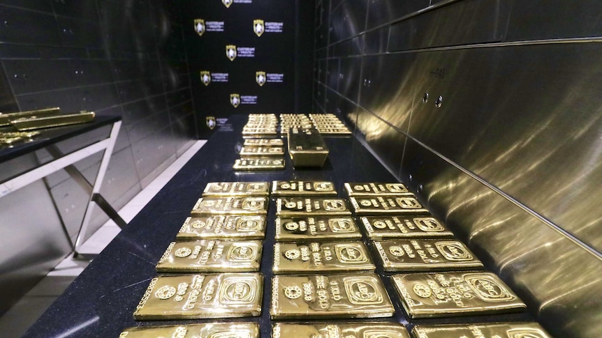 A table with bars of gold on it inside a vault in Sydney.