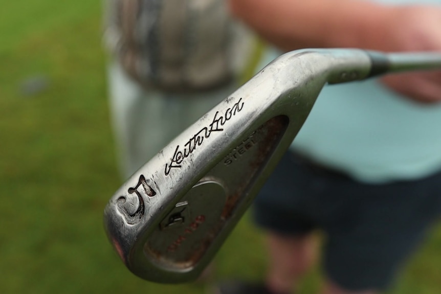A close up of a five iron golf club