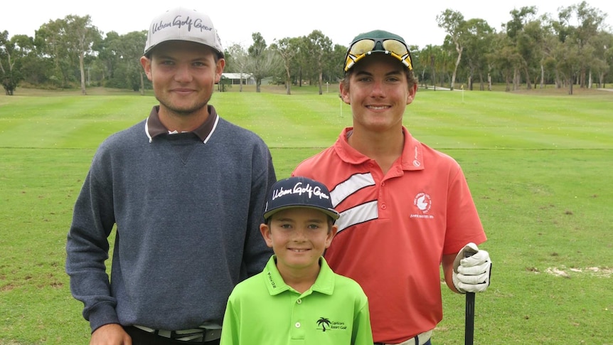 Three brothers stand at a golf driving range in central Queensland.