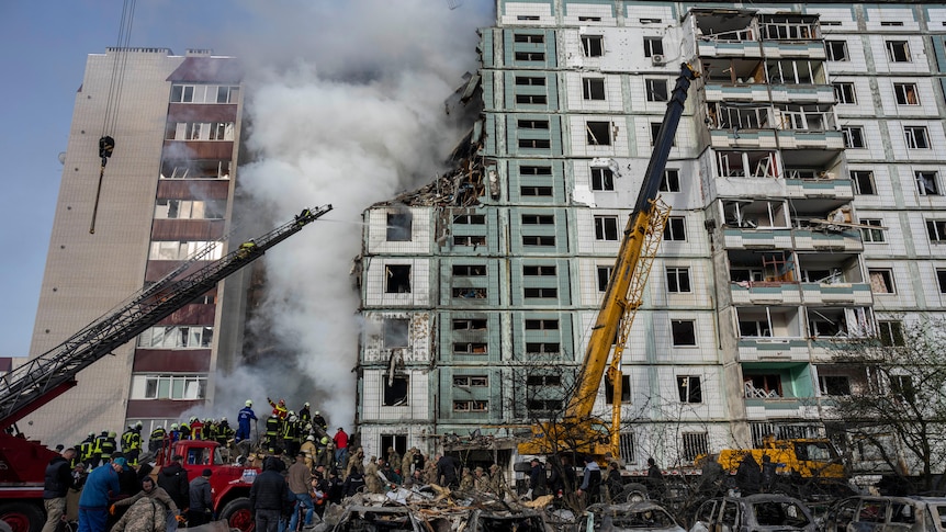 Firefighters work to extinguish a fire after a Russian attack at a residential building