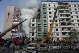 Firefighters work to extinguish a fire after a Russian attack at a residential building