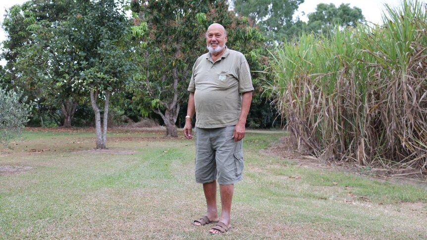 Wide photo of Adbul Ghani Mohammed standing in front of his cane paddock.