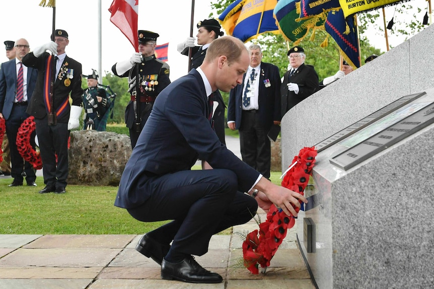 Prince William lays a wreath during a British service to mark the 75th anniversary at the National Memorial Arboretum in England