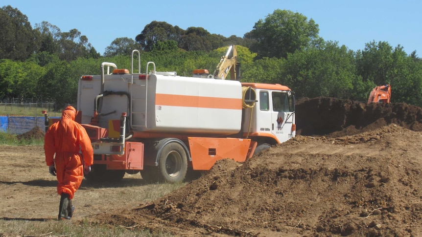 Asbestos removalists have begun taking away contaminated soil piles from the development site in Campbell.