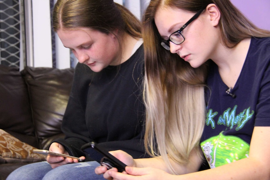 Kaitlin and Hayley on their phones