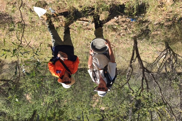 Chris Cairns, Stavely Resources, with offsider Quanda, standing in bush at exploration site