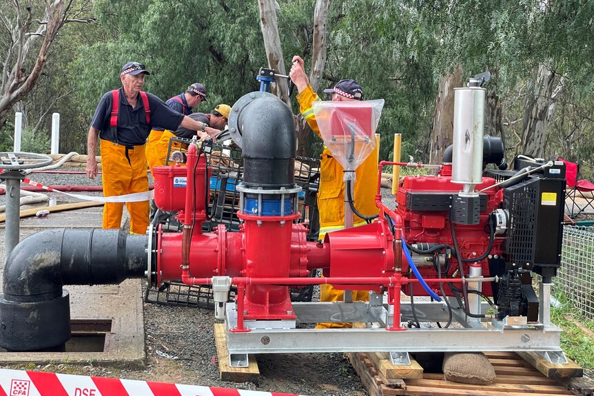 a large flood pump with SES workers nearby.