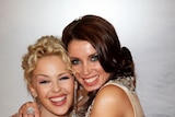 Kylie and Dannii Minogue embrace