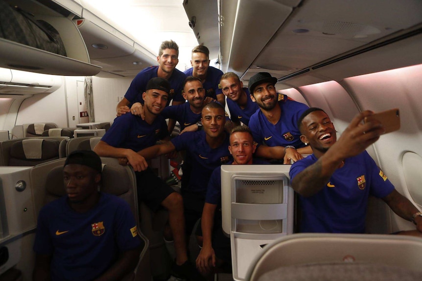 FC Barcelona men's team take a quick photo in business class on its way to the US.