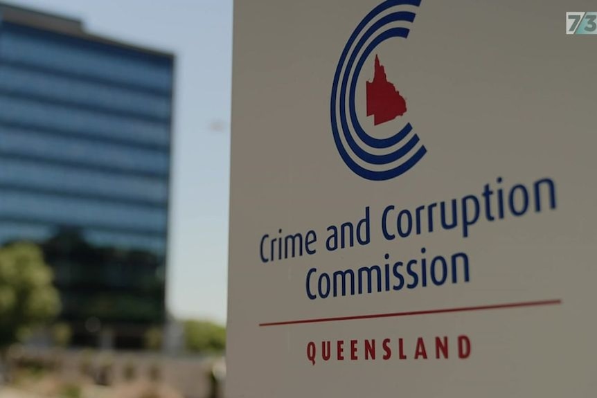 A Crime and Corruption Commission sign outside a building