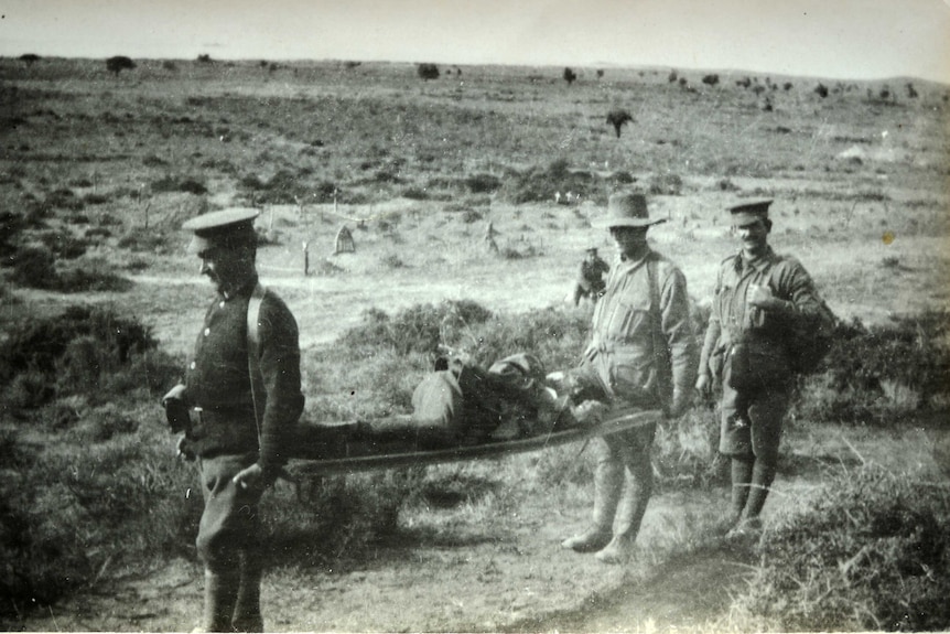 Two men carrying injured soldier on stretcher with third man at Suvla World War 1