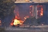 Flames engulf a house